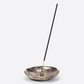 Incense burner with a single incense stick on a white background