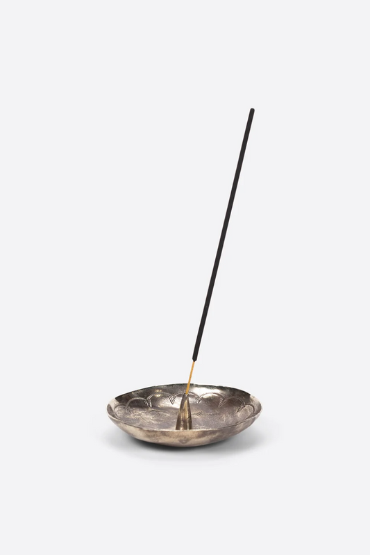 Incense burner with a single incense stick on a white background