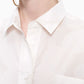 Marimekko Kasvio button-up shirt is made of a light, thin cotton in the beige and off white Unikko (poppy) pattern